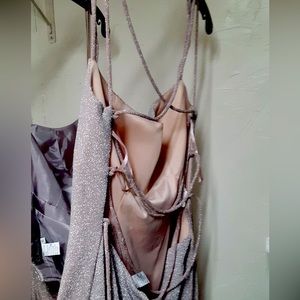 Long rose gold dress with slit and open back.